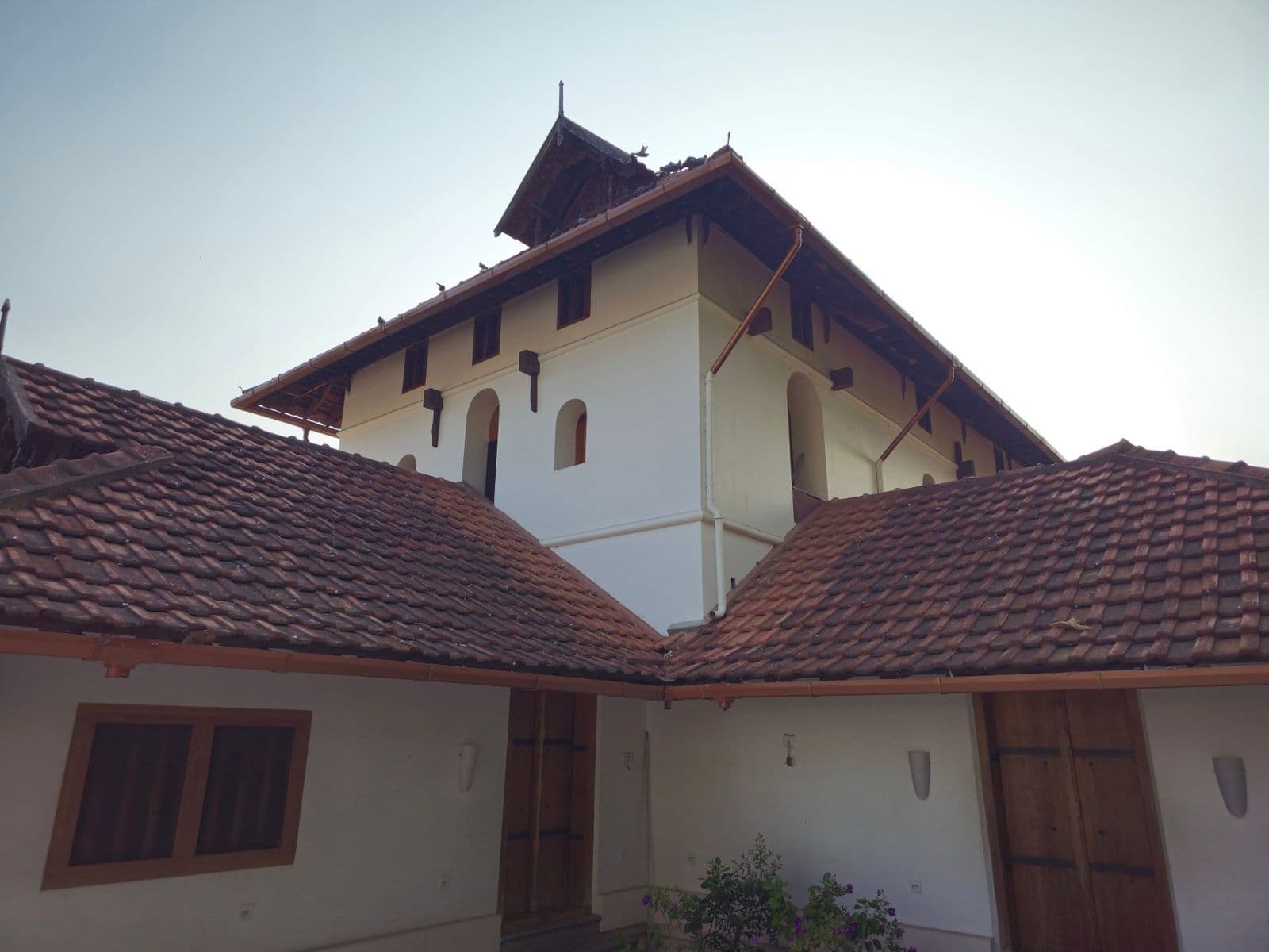 The tiled, Kerala-style roofs of Cheraman Juma Masjid against the sky