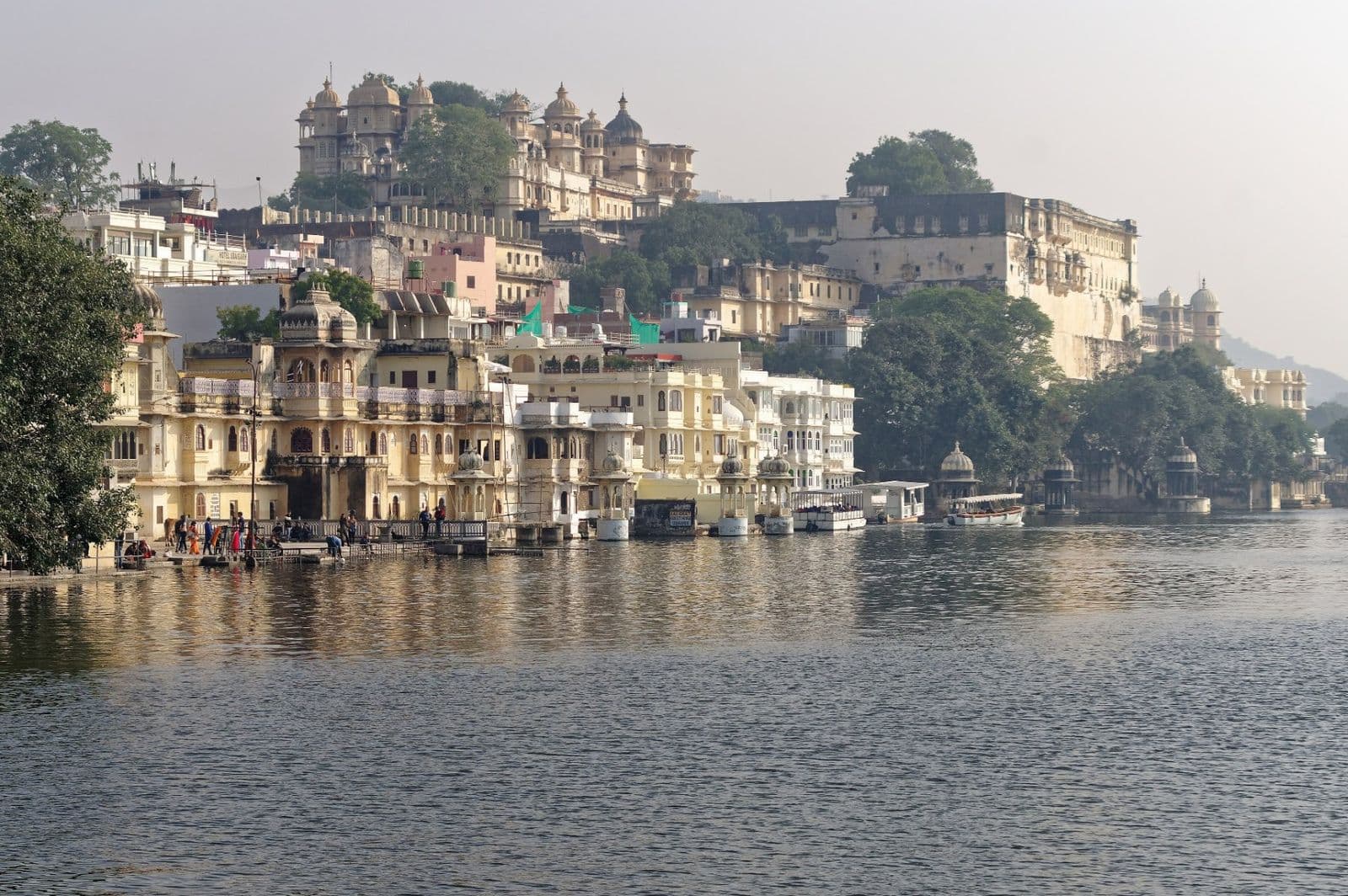 Ghats and old houses on the bank of Lake Pichola with the City Palace behind